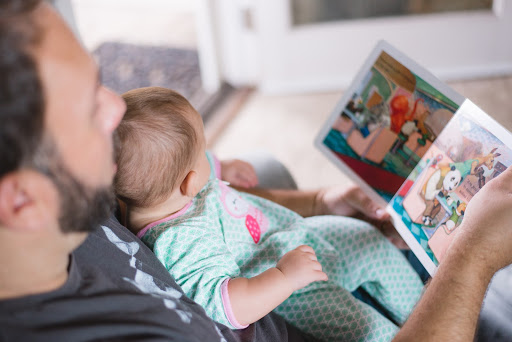 man reading to baby