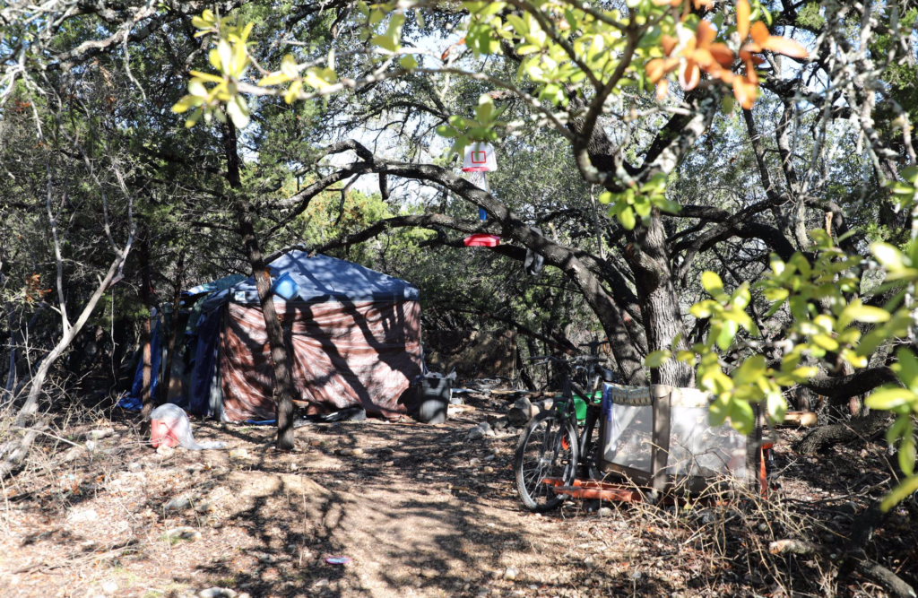 Playpen and basketball hoop outside a tent home made by San Antonio homeless family