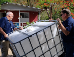 Water cisterns are delivered to a Puerto Rico community devestated by Hurricane Maria